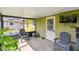 Back screened porch with furniture and view of the backyard at 206 Montana Ave, St Cloud, FL 34769