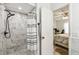 Bathroom shower with marble-style tiling and modern black shower head at 206 Montana Ave, St Cloud, FL 34769