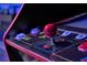 Close-up of arcade game controls in the modern finished basement game room at 2624 Daulby St, Kissimmee, FL 34747
