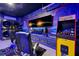Unique basement showcasing a laundry area and game room featuring a Pac-Personal arcade game and TV for entertainment at 2624 Daulby St, Kissimmee, FL 34747