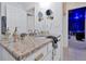 Bathroom with granite counters, white cabinets, and gold fixtures at 2624 Daulby St, Kissimmee, FL 34747