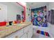 bathroom featuring a granite vanity, colorful accents, and themed shower curtain at 2624 Daulby St, Kissimmee, FL 34747