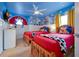 Playful themed bedroom with two twin beds, custom murals, and whimsical decor, perfect for children at 2624 Daulby St, Kissimmee, FL 34747