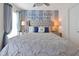 This charming bedroom includes a wish on the wall, large bed, decorative pillows, and curtains at 2624 Daulby St, Kissimmee, FL 34747