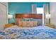 Comfortable bedroom showcasing a wooden headboard, colorful pillows, and matching yellow nightstands with lamps at 2624 Daulby St, Kissimmee, FL 34747