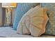 Closeup of pillows on bed, including a decorative shell-shaped pillow at 2624 Daulby St, Kissimmee, FL 34747