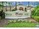 Windsor Hills Clubhouse sign surrounded by lush landscaping and colorful flowers, showing the entrance to the community at 2624 Daulby St, Kissimmee, FL 34747