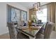 Formal dining room with stylish light fixture, seating for six, and decorative wall art at 2624 Daulby St, Kissimmee, FL 34747