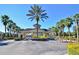 Community entrance surrounded by palm trees and a well-maintained landscape at 2624 Daulby St, Kissimmee, FL 34747