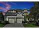 Charming two-story home featuring a well-manicured lawn, two-car garage and covered entryway at 2624 Daulby St, Kissimmee, FL 34747