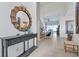 Inviting foyer with console table and mirror, leading to bright interiors and staircase at 2624 Daulby St, Kissimmee, FL 34747