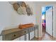 Hallway view with decorative wall art, a stylish console table, and a glimpse into a playful bedroom at 2624 Daulby St, Kissimmee, FL 34747