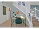 Hallway featuring a desk and staircase, enhanced by charming decor and bright natural light at 2624 Daulby St, Kissimmee, FL 34747