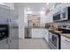 Bright kitchen featuring stainless steel appliances, granite countertops and backsplash at 2624 Daulby St, Kissimmee, FL 34747