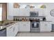 Well-equipped kitchen with white cabinets, stainless steel appliances, and granite countertops at 2624 Daulby St, Kissimmee, FL 34747