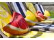 Closeup of a row of lounge chairs adorned with colorful towels and playful fruit pillows at 2624 Daulby St, Kissimmee, FL 34747
