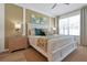 This spacious main bedroom features a large window, a ceiling fan, and beachy decor throughout at 2624 Daulby St, Kissimmee, FL 34747