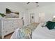 Relax in this bedroom, which features a flat screen TV, tropical decor, and white trim at 2624 Daulby St, Kissimmee, FL 34747