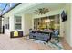 Covered patio has an outdoor dining area, perfect for entertaining by the pool at 2624 Daulby St, Kissimmee, FL 34747