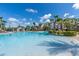 Large community pool with water slides, palm trees, and plenty of space for recreation at 2624 Daulby St, Kissimmee, FL 34747