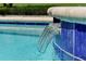 Modern water feature showcasing decorative blue tiles and pool edge at 2624 Daulby St, Kissimmee, FL 34747