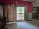 Dining room showcasing tiled floors, a large window, a chandelier, and red painted walls at 2638 S Laurel Ave, Sanford, FL 32773