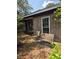 Seating area in front yard with weathered bench and chairs, shaded by mature trees at 2638 S Laurel Ave, Sanford, FL 32773