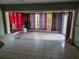 Spacious living room featuring tiled floors, large windows with curtains, and paneled walls at 2638 S Laurel Ave, Sanford, FL 32773