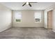 Neutral bedroom features a ceiling fan, plush carpeting, and lots of natural light at 2932 Muller Oak Loop, Ocoee, FL 34761