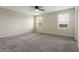 Bedroom with soft carpeting, ceiling fan, and a view from the windows at 2932 Muller Oak Loop, Ocoee, FL 34761