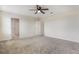 Spacious carpeted bedroom with ceiling fan and multiple doorways at 2932 Muller Oak Loop, Ocoee, FL 34761