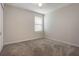 Bright bedroom with plush carpeting and a window at 2932 Muller Oak Loop, Ocoee, FL 34761