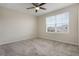 Comfortable bedroom with a ceiling fan, neutral walls and soft carpeting at 2932 Muller Oak Loop, Ocoee, FL 34761