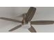 A modern ceiling fan with wooden blades provides efficient cooling and complements the room's decor at 2932 Muller Oak Loop, Ocoee, FL 34761