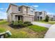 Charming two-story home featuring a two-car garage, neutral stucco exterior, and a neatly paved driveway at 2932 Muller Oak Loop, Ocoee, FL 34761