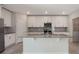 Spacious kitchen with stainless steel appliances, plenty of storage, and an island with a sink at 2932 Muller Oak Loop, Ocoee, FL 34761