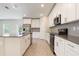 Well-lit kitchen featuring stainless steel appliances, white cabinetry, and a large kitchen island at 2932 Muller Oak Loop, Ocoee, FL 34761