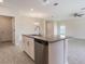 Stylish kitchen island with stainless steel dishwasher, neutral countertop, and ample space for meal preparation at 2932 Muller Oak Loop, Ocoee, FL 34761