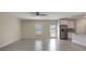 Bright open-concept living area with tile flooring, ceiling fan, and seamless flow into the adjacent kitchen at 2932 Muller Oak Loop, Ocoee, FL 34761