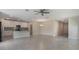 Bright open-concept living area with tile flooring, ceiling fan, and seamless flow into the adjacent kitchen at 2932 Muller Oak Loop, Ocoee, FL 34761