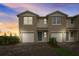 Charming townhome exterior with attached garages and manicured landscaping at 2971 Brie Hammock Bnd, St Cloud, FL 34773