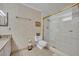 Bathroom showcasing a shower-tub combo with glass doors and a neutral color scheme at 300 Carolina Ave # 304, Winter Park, FL 32789
