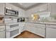 Kitchen area featuring modern appliances, white cabinetry, and wood floors at 300 Carolina Ave # 304, Winter Park, FL 32789