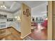 Open-concept view of kitchen and living room with wood floors and lots of natural light at 300 Carolina Ave # 304, Winter Park, FL 32789