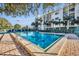 Inviting outdoor pool surrounded by lush greenery and condominium building, perfect for relaxation at 300 Carolina Ave # 304, Winter Park, FL 32789