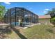 An aerial view of the backyard pool with a screened enclosure and grass at 3606 Palm Ave, Apopka, FL 32703