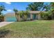 Charming single-story home with a well-maintained lawn and a lovely teal-colored garage door at 3606 Palm Ave, Apopka, FL 32703