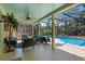 Covered patio boasts outdoor seating, ceiling fan, and pool views at 3606 Palm Ave, Apopka, FL 32703