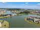 Scenic aerial view of a large lake with a bridge, surrounded by homes and lush landscaping at 3966 Steer Beach Pl, Kissimmee, FL 34746