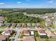 Aerial view of a community featuring beautiful landscaping and a mixture of tile roofed homes at 3966 Steer Beach Pl, Kissimmee, FL 34746